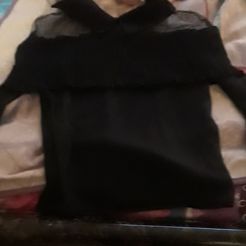 A black long sleeve ruffle blows